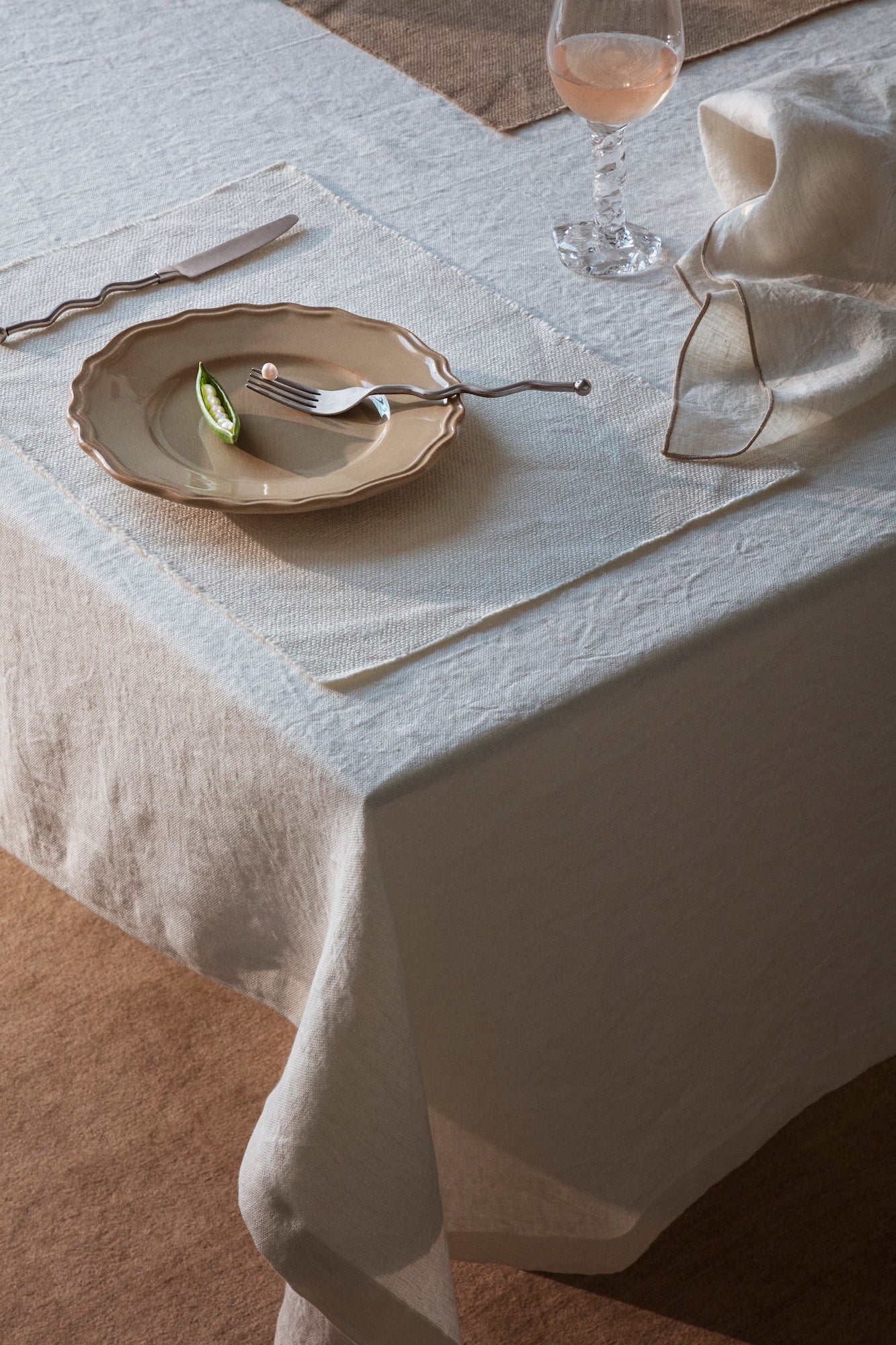 Elegant TAMEKO linen tablecloth with Rue placemat, plate, napkin, and wine glass