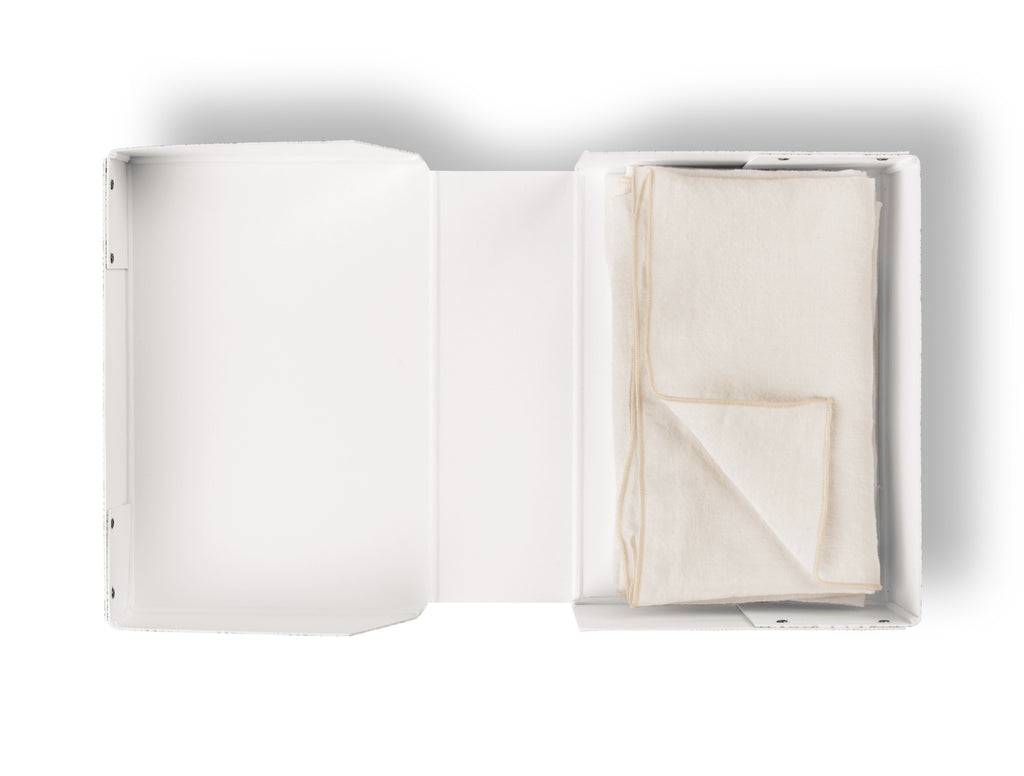 Natural linen napkin neatly folded in white packaging, TAMEKO table textile