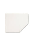 TAMEKO white kitchen towel with folded corner on plain background, minimalist home textile