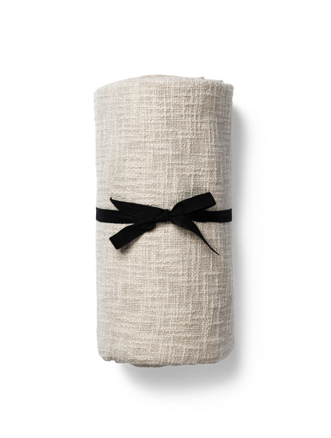 Natural textured bed runner from TAMEKO, rolled with black ribbon on white background
