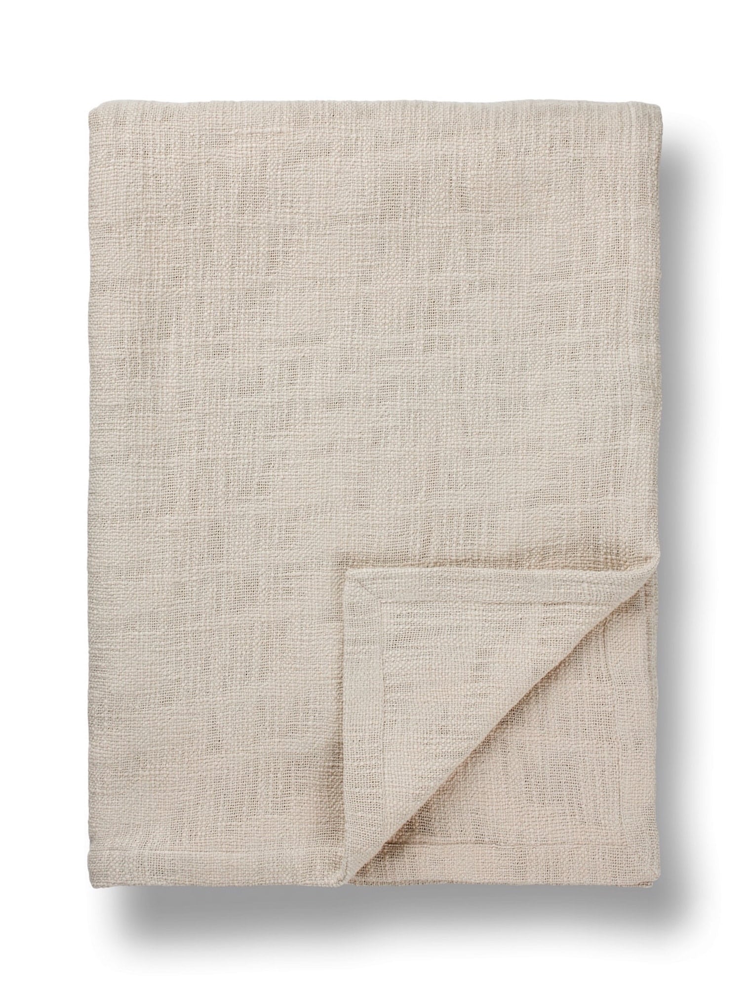 Natural linen bed throw with woven texture, neutral color, folded, TAMEKO home fabric